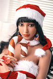 A closeup shot of beautiful Mazia, a tanned-skin love companion with a curvy figure and huge breasts. She is seated and rests her chin on an oversized prop cancy cane, wearing a Santa's hat and a Santa-themed top.