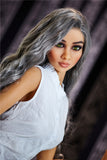 Lovely Am, a 5ft 5in love doll, in her white shirt and wavy silver hair, tilting her head.